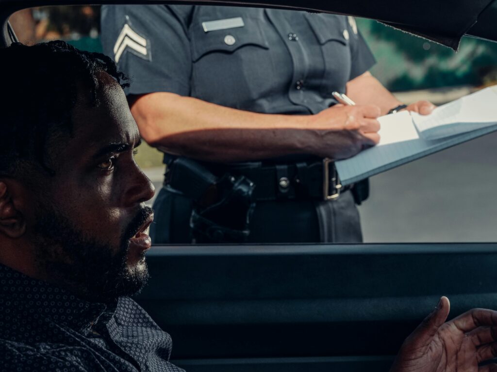 A police officer issuing a ticket to a driver during a traffic stop.